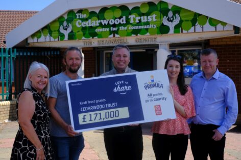 Primula team presenting cheque to Cedarwood Trust